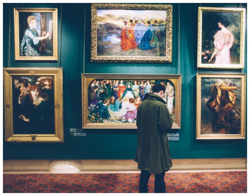 Person views classic artworks in an elegant galler
