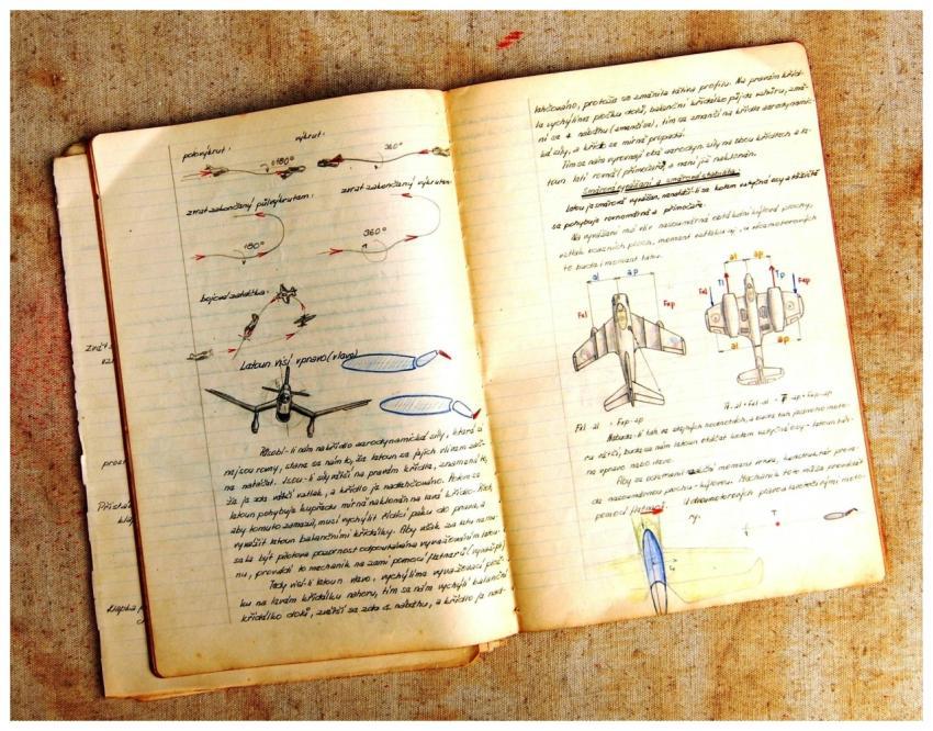 Open vintage notebook showing airplane diagrams an