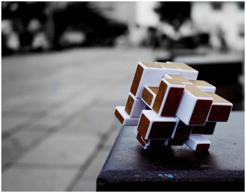 Artistic cube puzzle placed on a surface in an urb