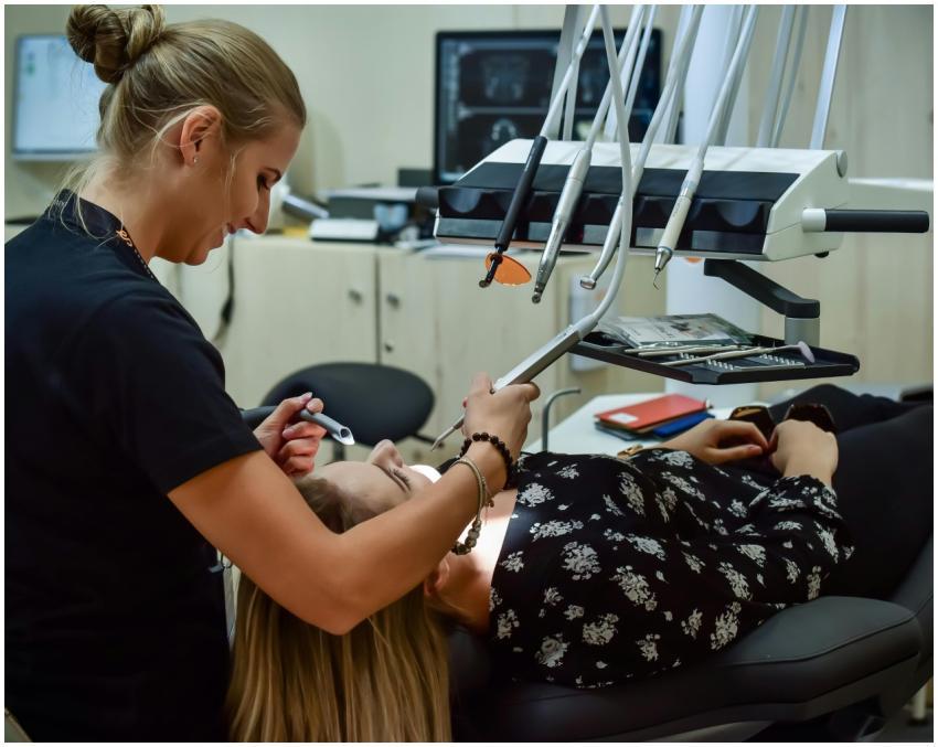 Dental professional conducting examination with ad