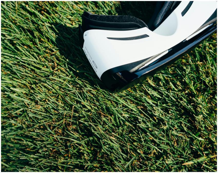 A close-up shot of VR goggles placed on a green gr