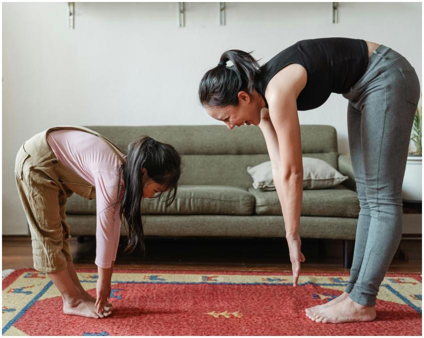 Side view of smiling young Asian woman stretching