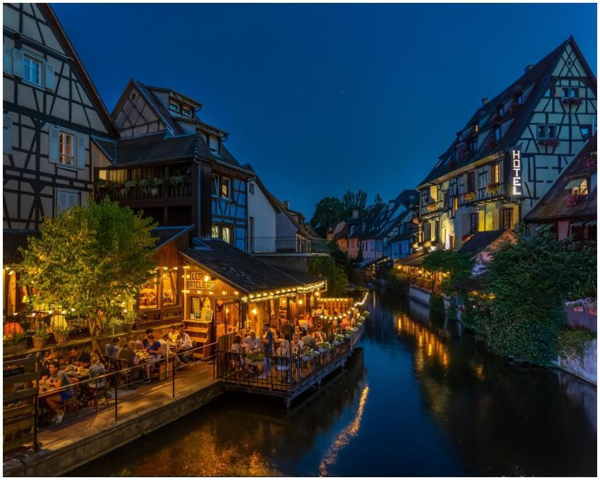 Nighttime view of Colmar's timbered houses and can