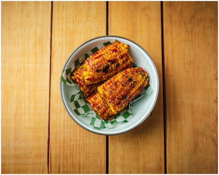 Savor the taste of grilled Mexican elotes drizzled