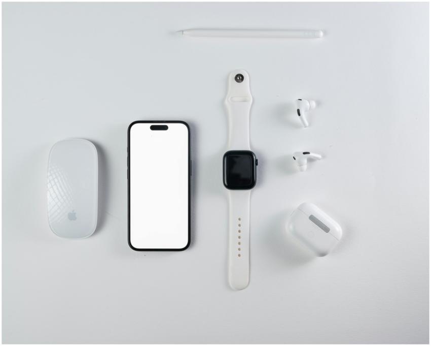 Minimalist flat lay of smartphone, smartwatch, wir