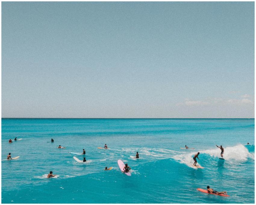Aerial photo of surfers riding waves in Hawaii's c