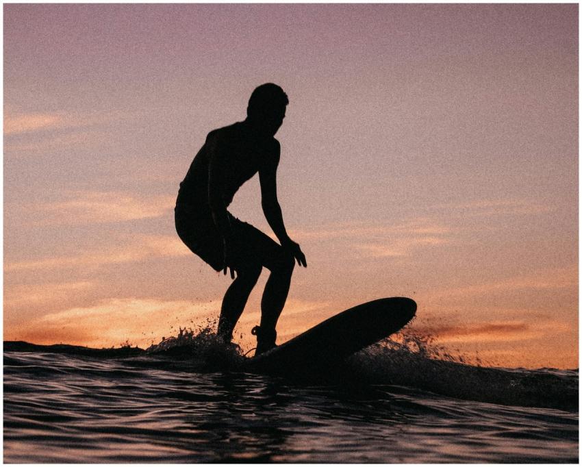 Captivating silhouette of a surfer riding waves at
