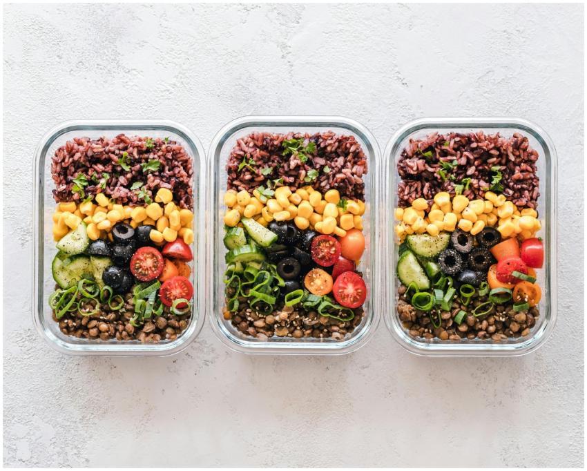 Colorful healthy meal prep with corn, olives, toma