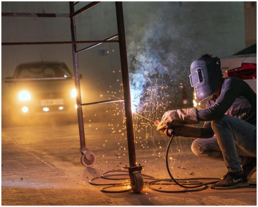 A welder at work with sparks flying in an industri