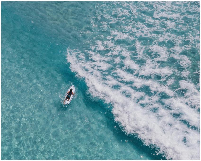 Surfer rides the crystal-clear waves of Waikiki be