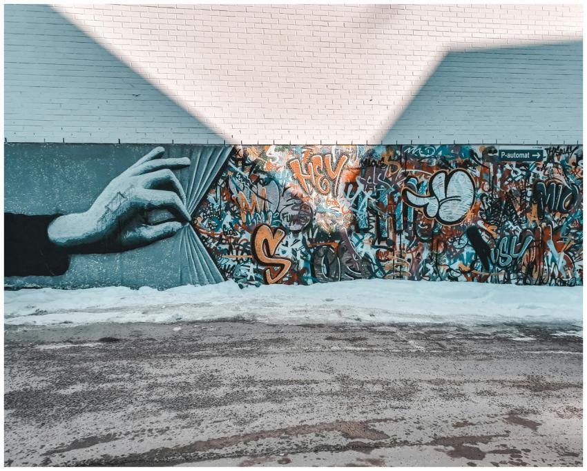 Colorful mural featuring a hand unveiling vibrant