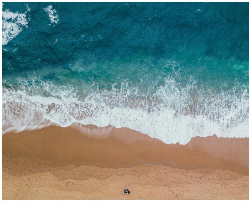 A stunning aerial shot capturing waves gently cras