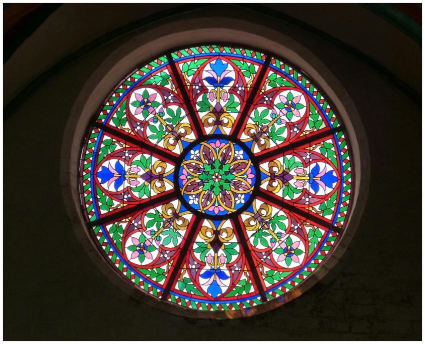 A colorful stained glass rose window with intricat