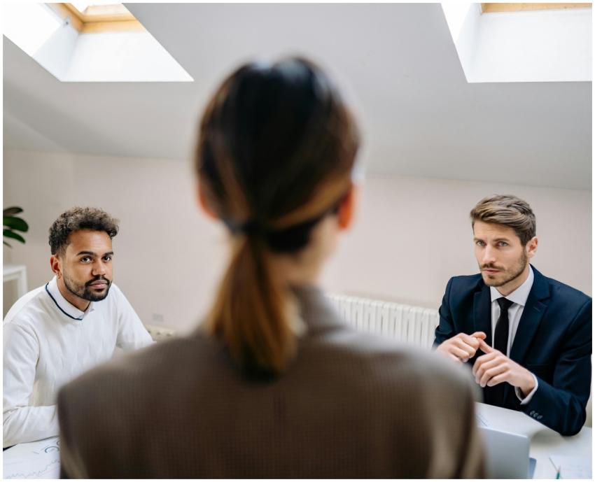 A professional business meeting involving three ad