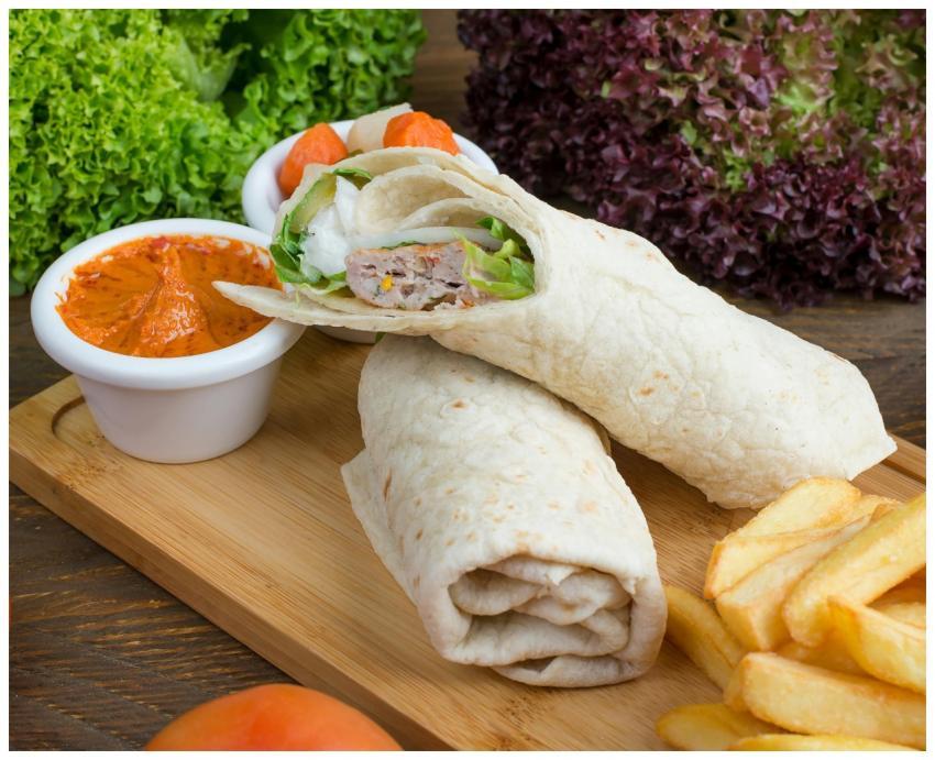 Tasty wraps served with fries and a spicy dip on a