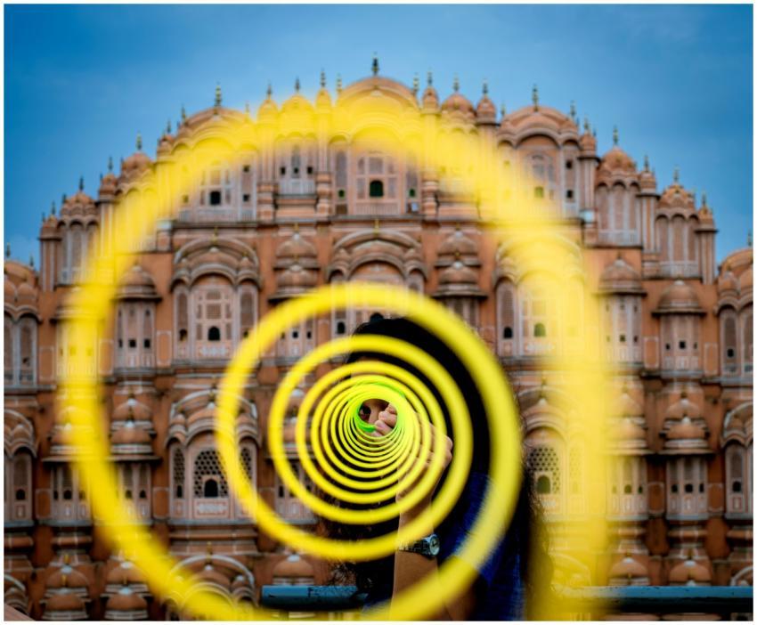 A colorful spiral art installation with Hawa Mahal