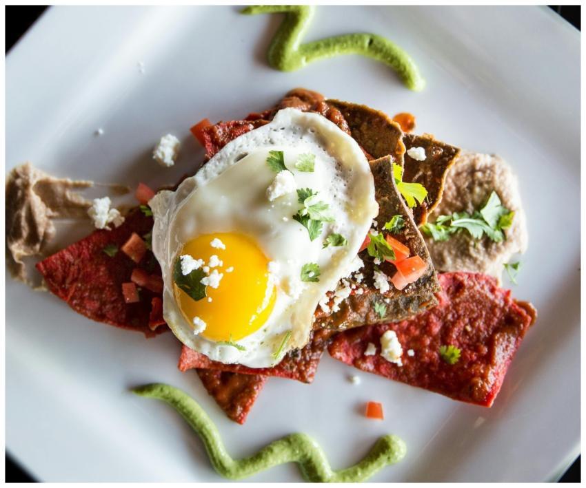 Delicious Mexican chilaquiles topped with a sunny-
