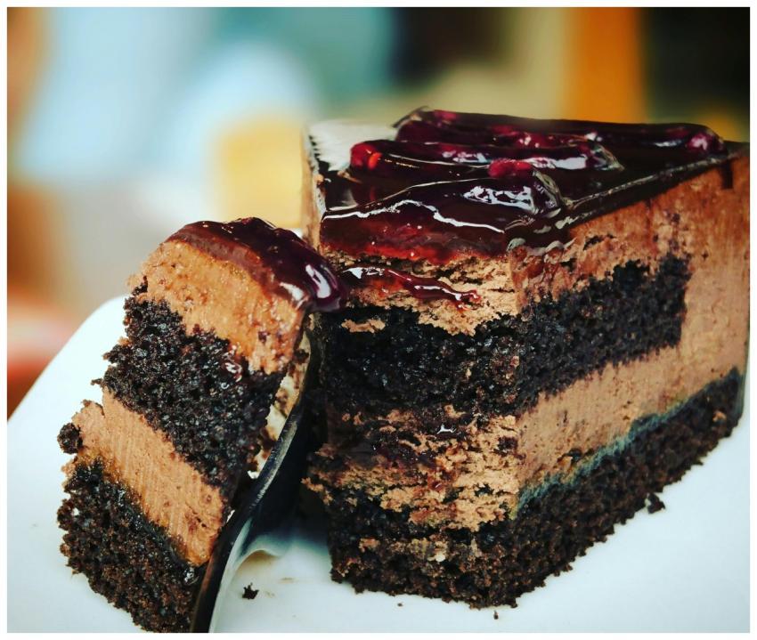 Close-up of a rich chocolate cake slice with blueb