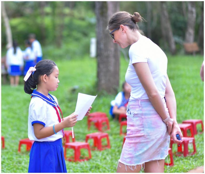 A child and adult engage in an outdoor educational