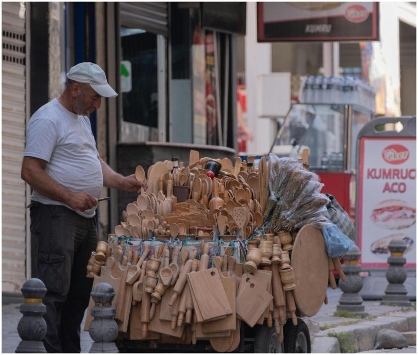 A street vendor offers handcrafted wooden kitchenw