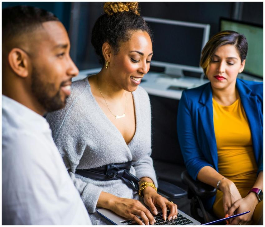 A diverse group of colleagues collaborates on a pr