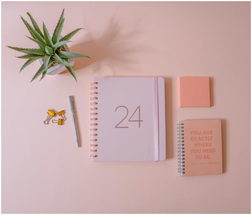 Peach-themed minimalist workspace showing planner,