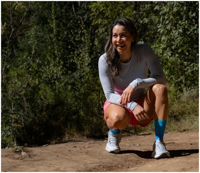 Smiling woman in sportswear takes a break during a