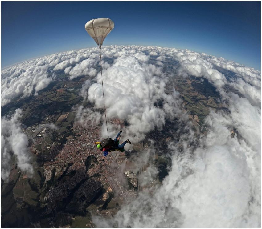 A thrilling aerial shot of a skydiver under parach