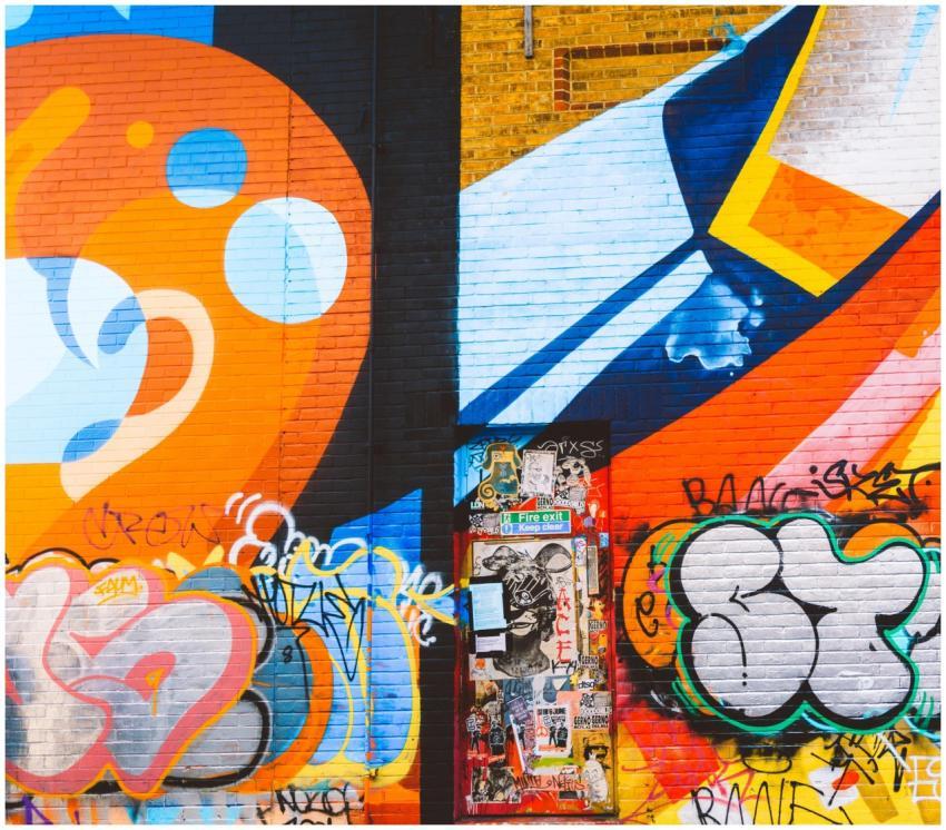 Colorful graffiti mural on a brick wall featuring