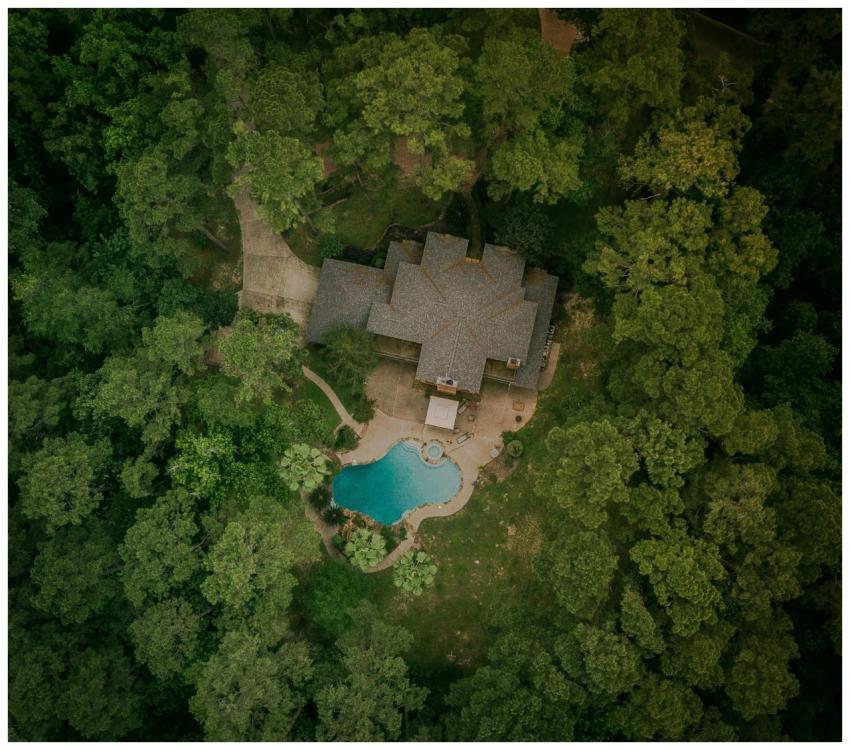A scenic aerial shot of a house surrounded by lush