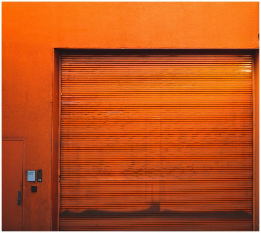 Rustic orange industrial garage door with textured