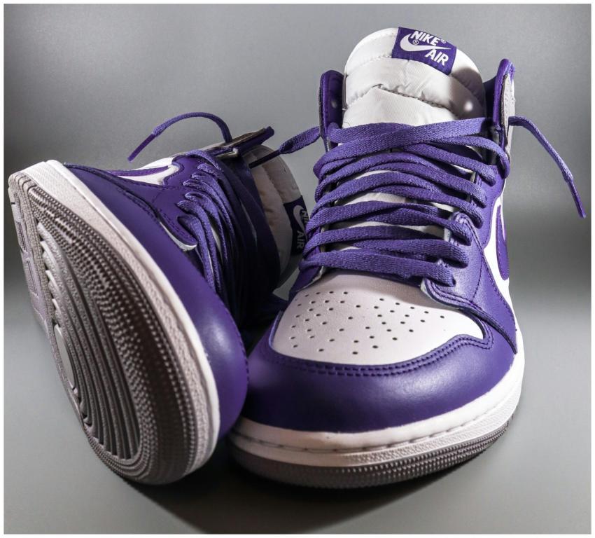A close-up studio shot of purple and white Nike Ai