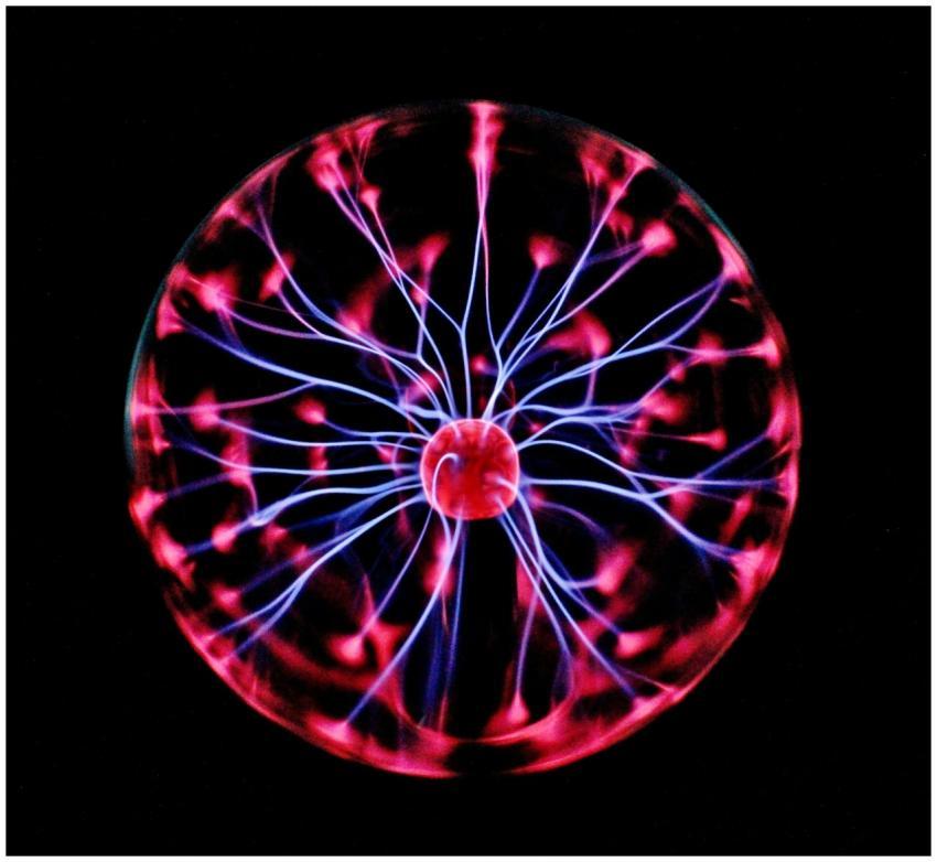 Close-up of a plasma globe with vibrant neon spark