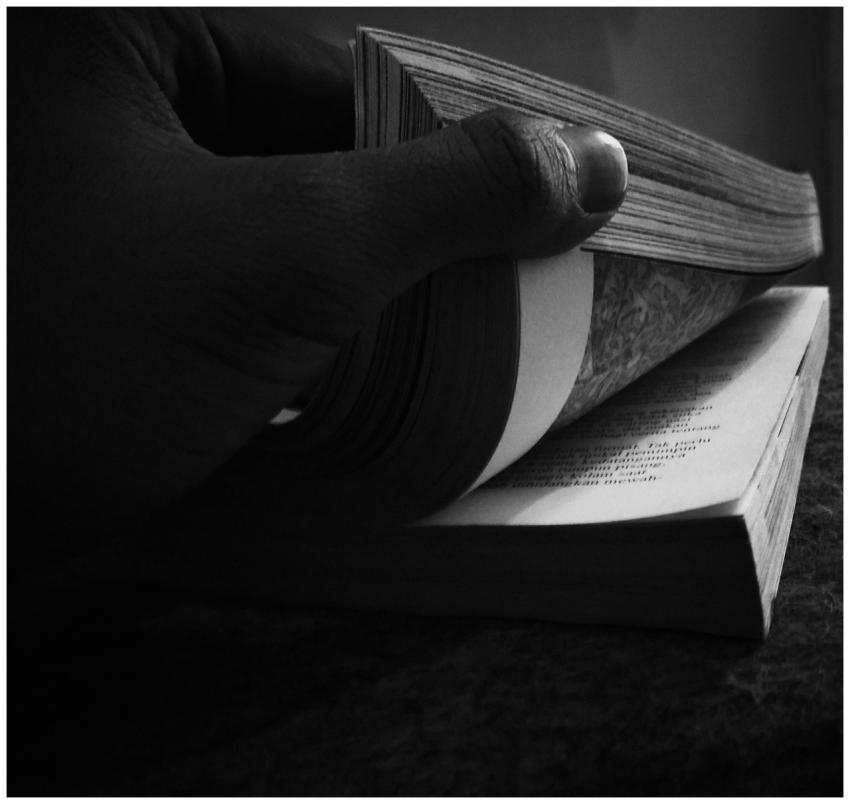 Black and white close-up of a hand flipping throug