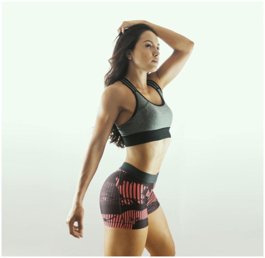 Young fitness model posing confidently in studio,