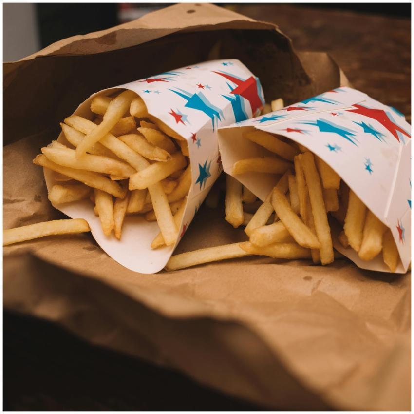 Golden crispy French fries in colorful star-patter