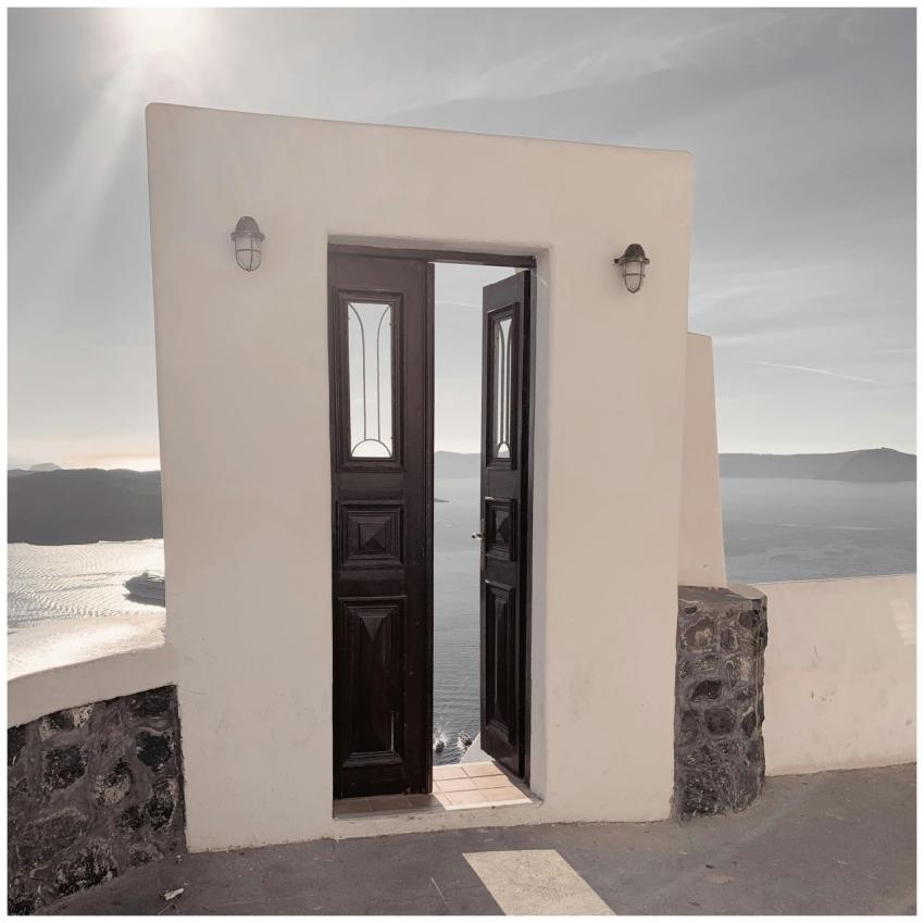 A classic Santorini doorway opens to reveal a stun
