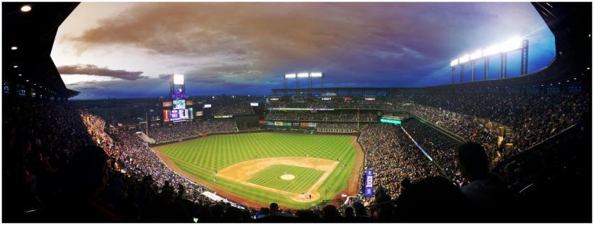 Wide-angle view of a baseball stadium at dusk capt