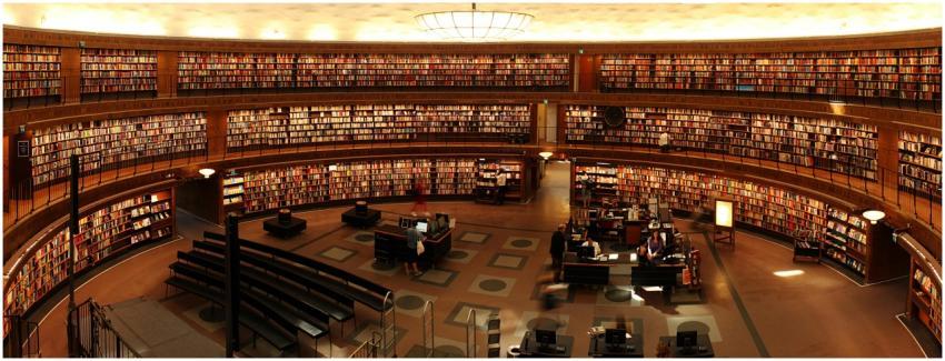 Panoramic view of a grand circular library with sh