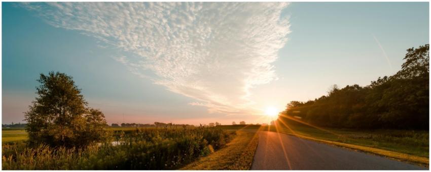 Beautiful sunrise over a tranquil rural road in Lo