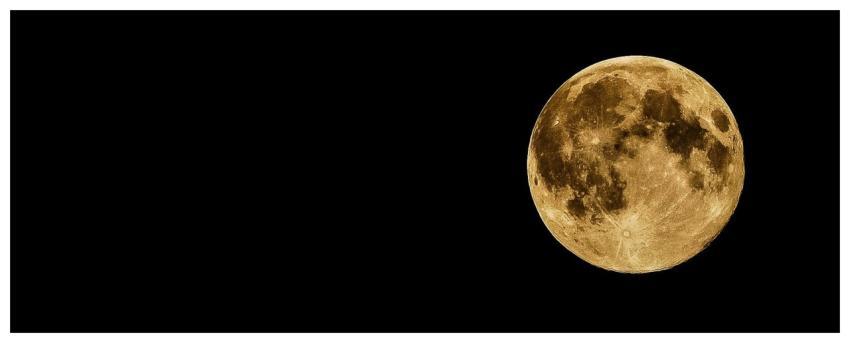 A vivid full moon against a dark, starless night s