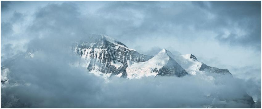 A serene view of snow-capped mountains surrounded