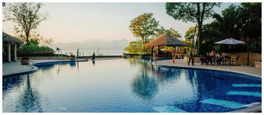 Serene resort pool with sunset views, ideal for re