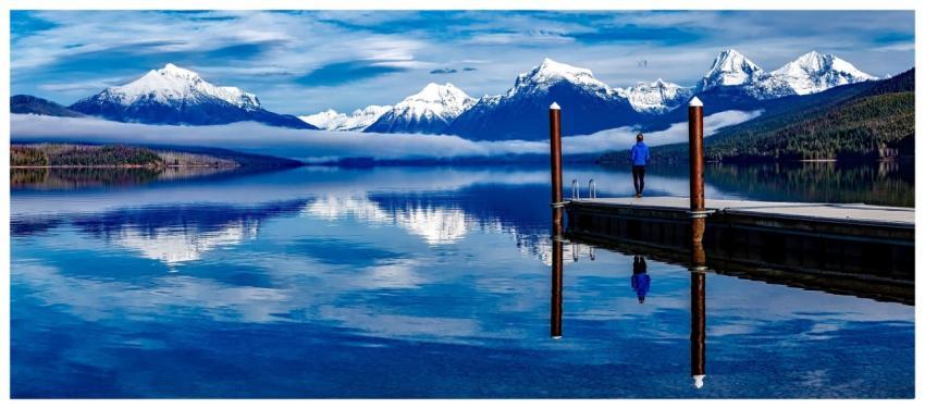 A serene lake with snowcapped mountains reflecting