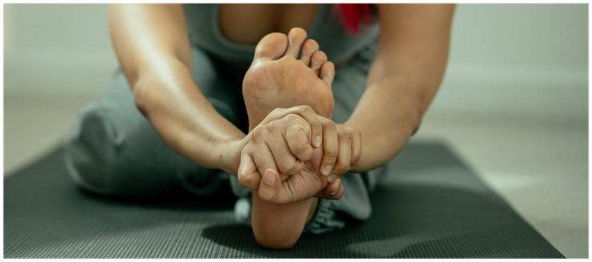 Crop anonymous flexible barefoot female in sportsw