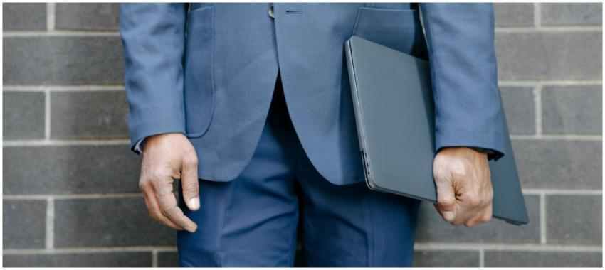 Close-up of a businessman in a blue suit holding a