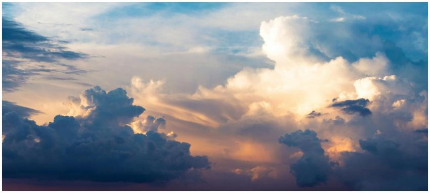 A stunning view of fluffy clouds and a colorful sk