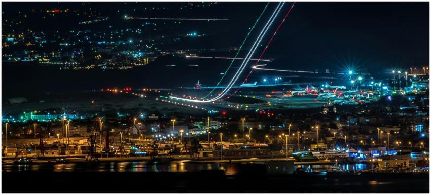 A vibrant cityscape featuring a busy airport and h