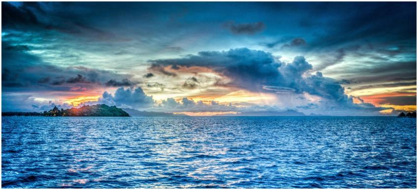 Vibrant sunset over tropical ocean with dramatic c