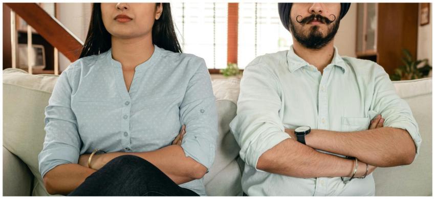 Crop thoughtful young man and woman in casual clot